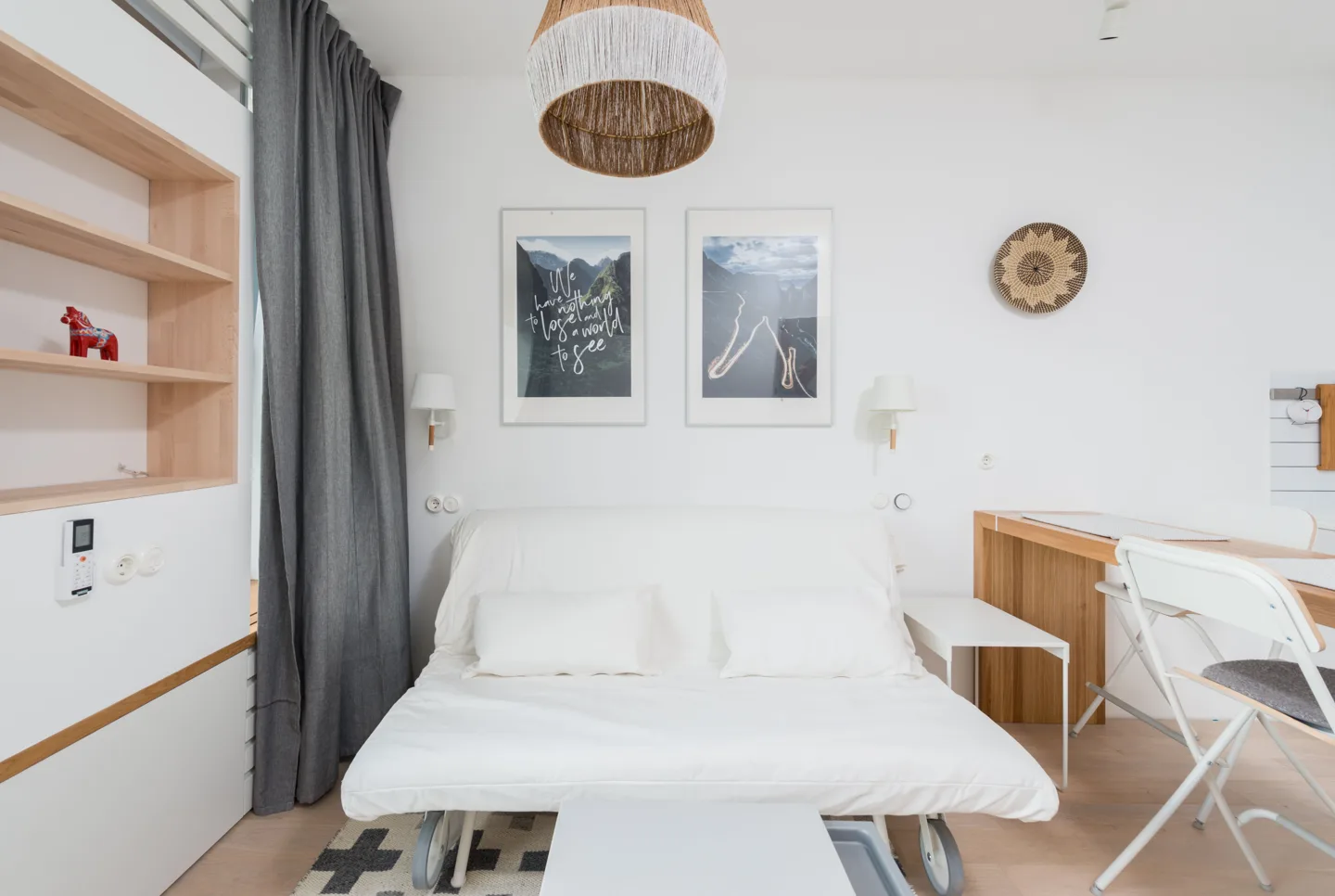 Light-filled studio interior with warm wood and a comfortable living area